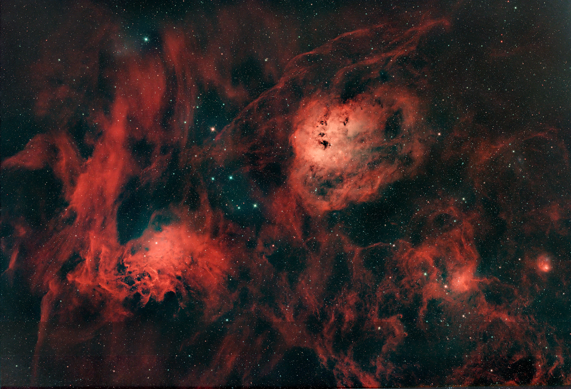 Flaming Star Nebula IC405 on the left and bluish Tadpole Nebula IC410 on the right above in the constellation Auriga